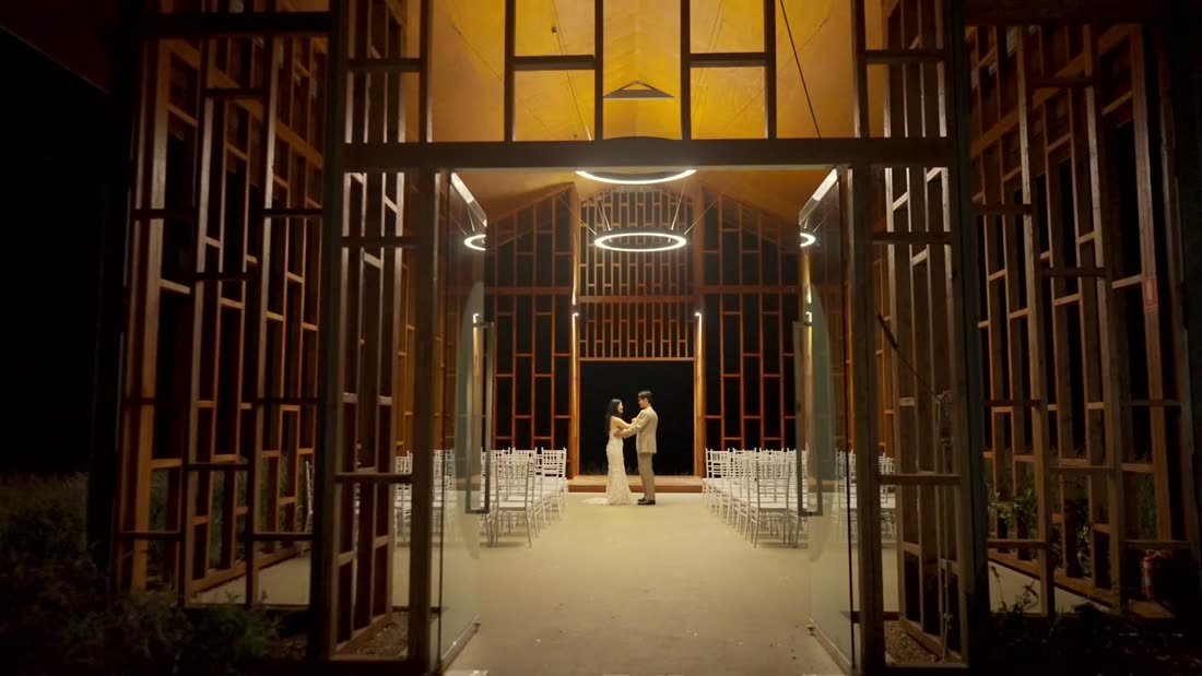 Couple inside a timber chapel at night